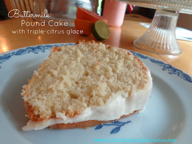 A single slice of tender buttermilk pound cake is on a blue ceramic dessert plate. The crumb looks fluffly and inviting and the simple citrus glaze looks rich and thick on top.