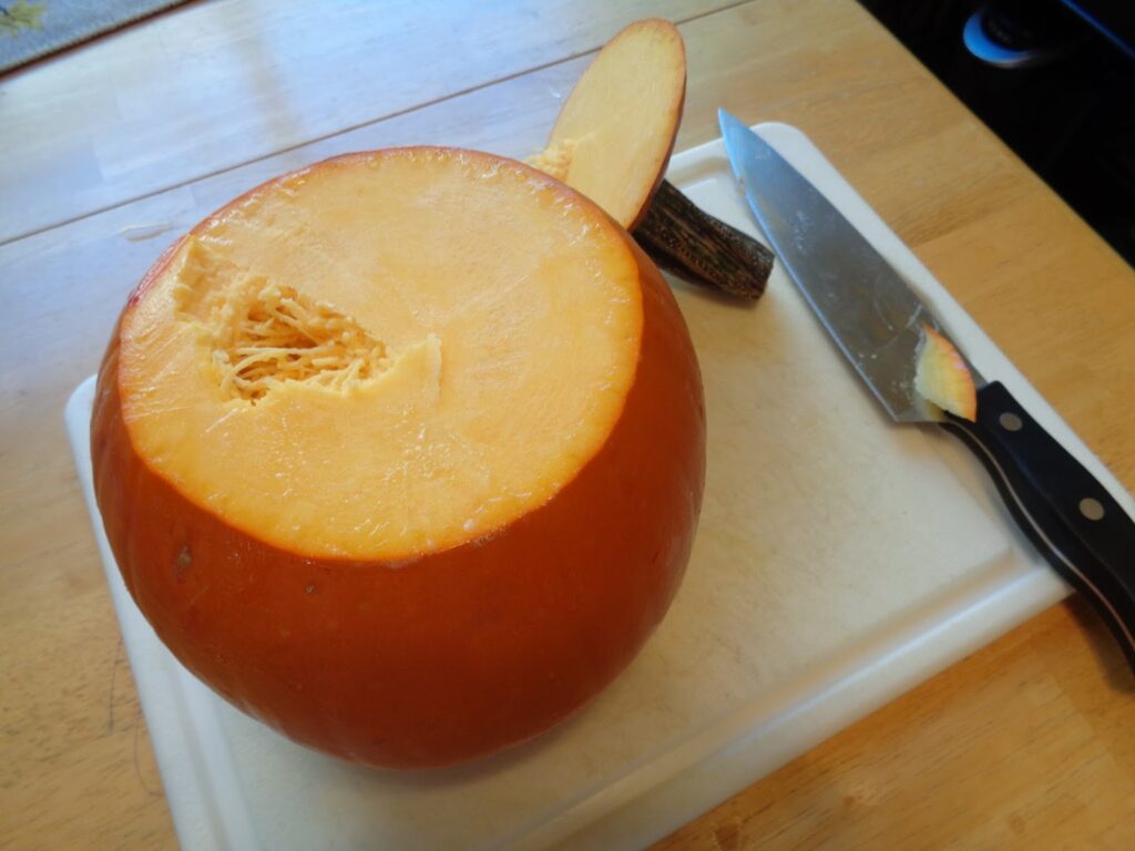 Removing the stem first creates a flat, steady surface; making it easier to cut to open the pumpkin up for cleaning. 