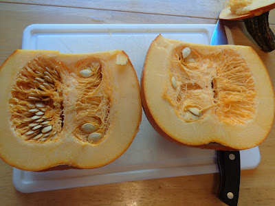 Now the pumpkin in two pieces and the stringy innards and seeds are exposed and ready to be cleaned out.