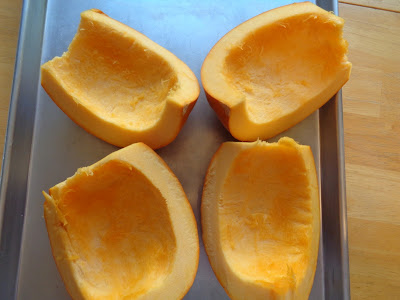 The pumpkin is in quartered and placed on a lightly greased rimmed cooking sheet. 