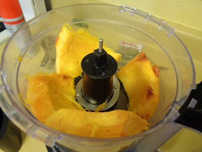 Cooked pumpkin is added to a food processor to make fresh puree. 