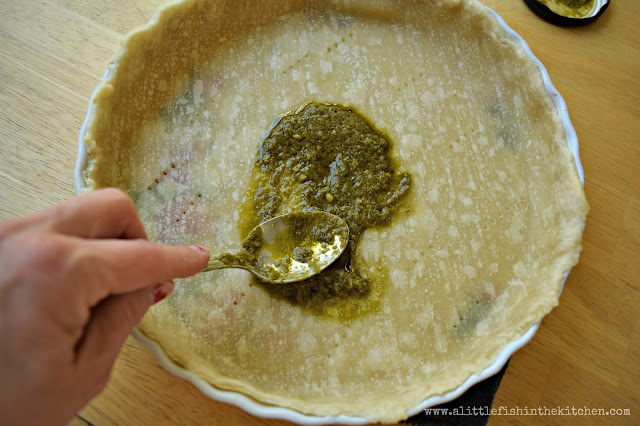 Flavorful prepared pesto is spread into a parbaked pie crust.