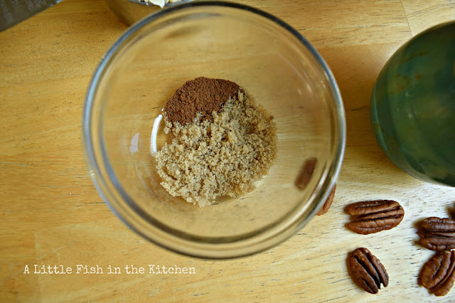 A small portion of light brown sugar and ground cinnamon are portioned out in a small glass bowl.