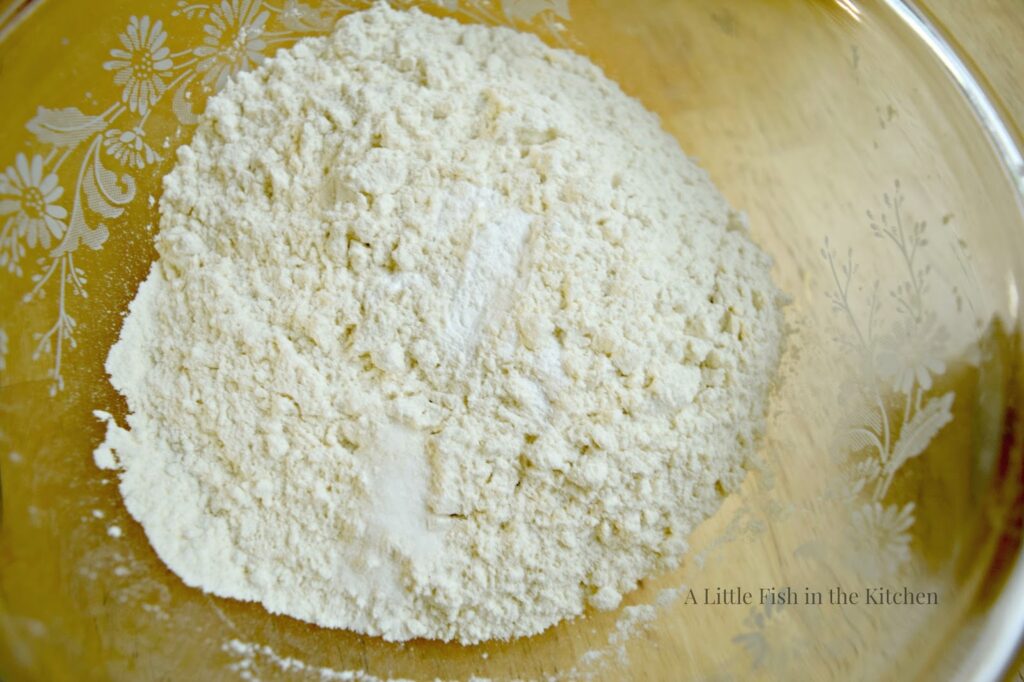The dry ingredients: all purpose flour, salt and baking powder are combined in a large glass mixing bowl. 