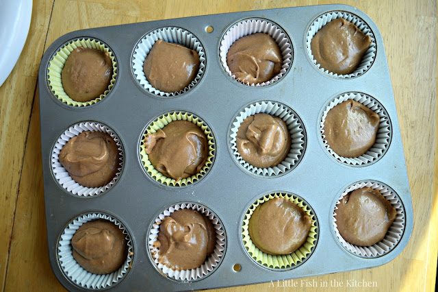 One dozen unbaked chocolate cupcakes are ready for the oven.
