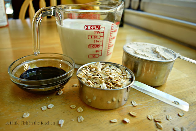 The main ingredients for making brown Irish soda bread: oats, wheat bread flour, molasses, and milk are all gathered and ready to use. 