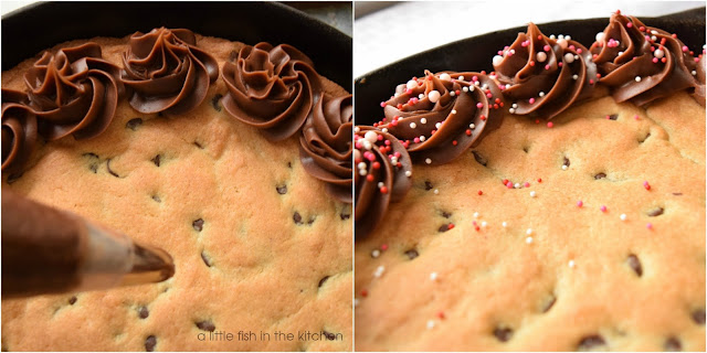 Chocolate icing swirls are piped around the edge of a skillet cookie using a large star tip. Swirls of icing give this simple dessert an elegant appearance. The final addition of colorful sprinkles over the icing give this skillet cookie the perfect pop of color for a celebration!