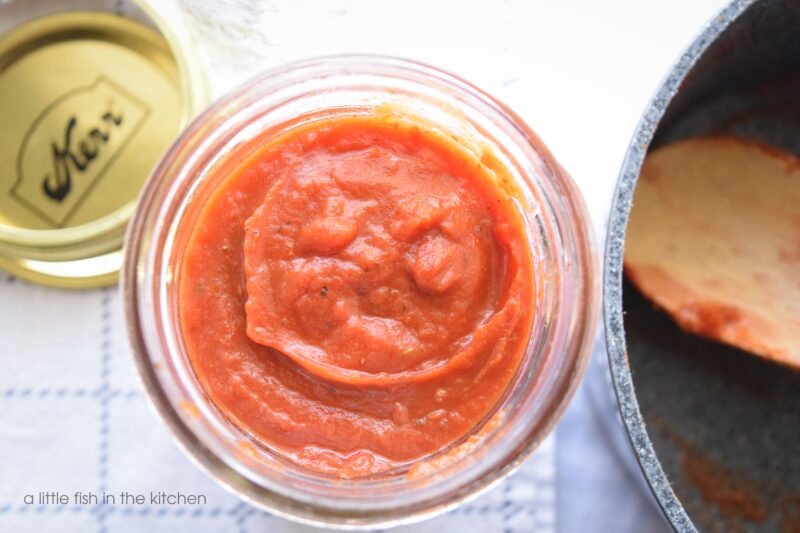 Fresh pizza sauce is thick and rich and easily stored in a clear glass mason jar. 