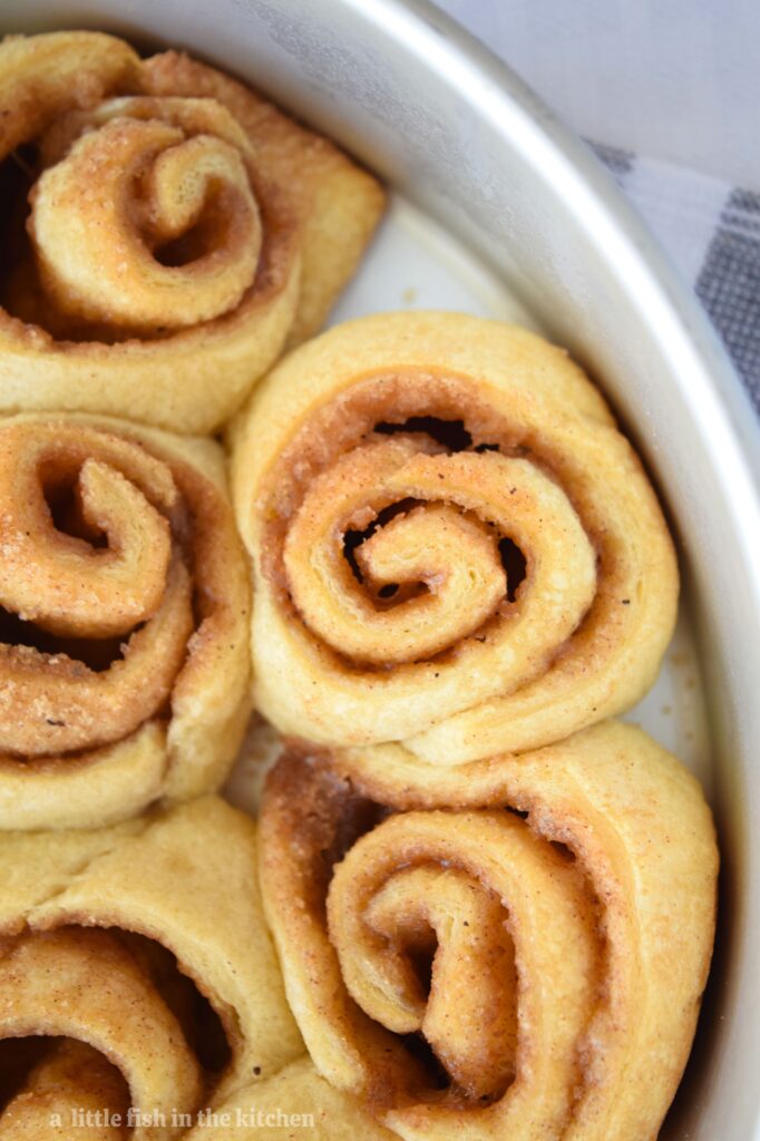 The cinnamon and sugar filling is shown around the edges of a fresh baked cinnamon roll. 