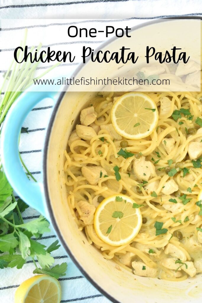 Pin image for Chicken Piccata Pasta. One half of a teal Dutch oven is seen and in it cooked spaghetti, bits of chicken and capers are visible. Lemon slices and chopped parsley are scatter on top of the pasta for garnish. A bunch of fresh parsely is visible on the side of the pot. 
