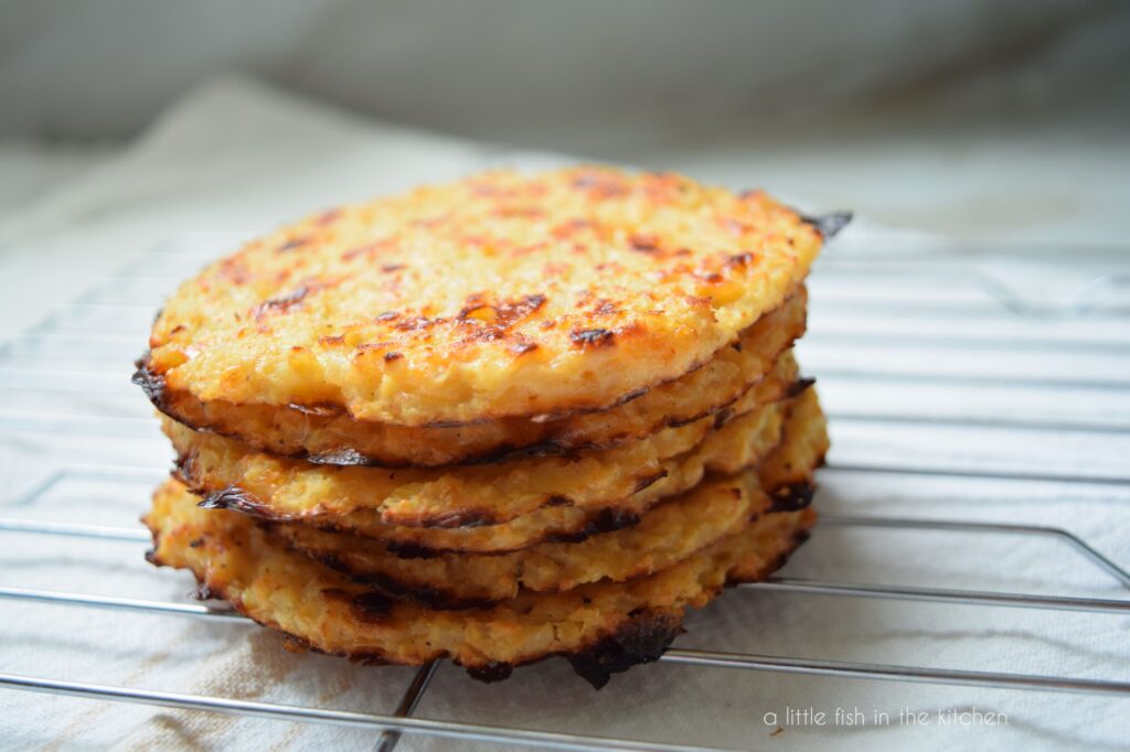 A stack of six homemade sandwich thins is sitting on a metal cooling rack. 