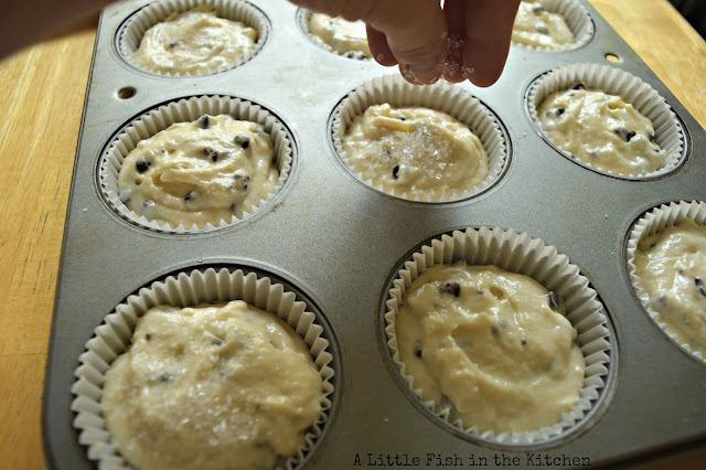 Course sparkling sugar is hand-sprinkled onto muffin batter in paper baking cups. 