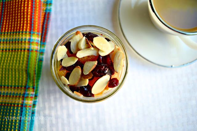 The delicious crunch toppings for these Vanilla-Orange Overnight Oats are shown close up. Petite mandarin oranges, dried cranberries, and sliced almonds make this breakfast something special.